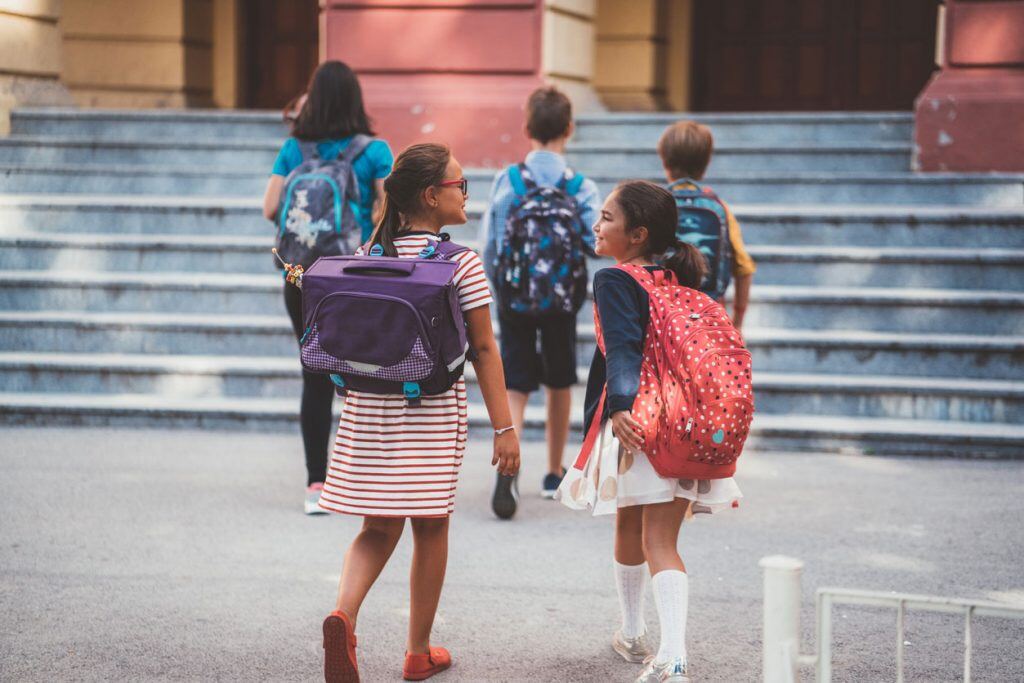 Friends walking together on the first day of school