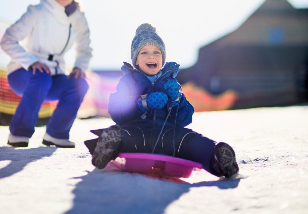 Boy Sledding Photography with Cold Winter Tones