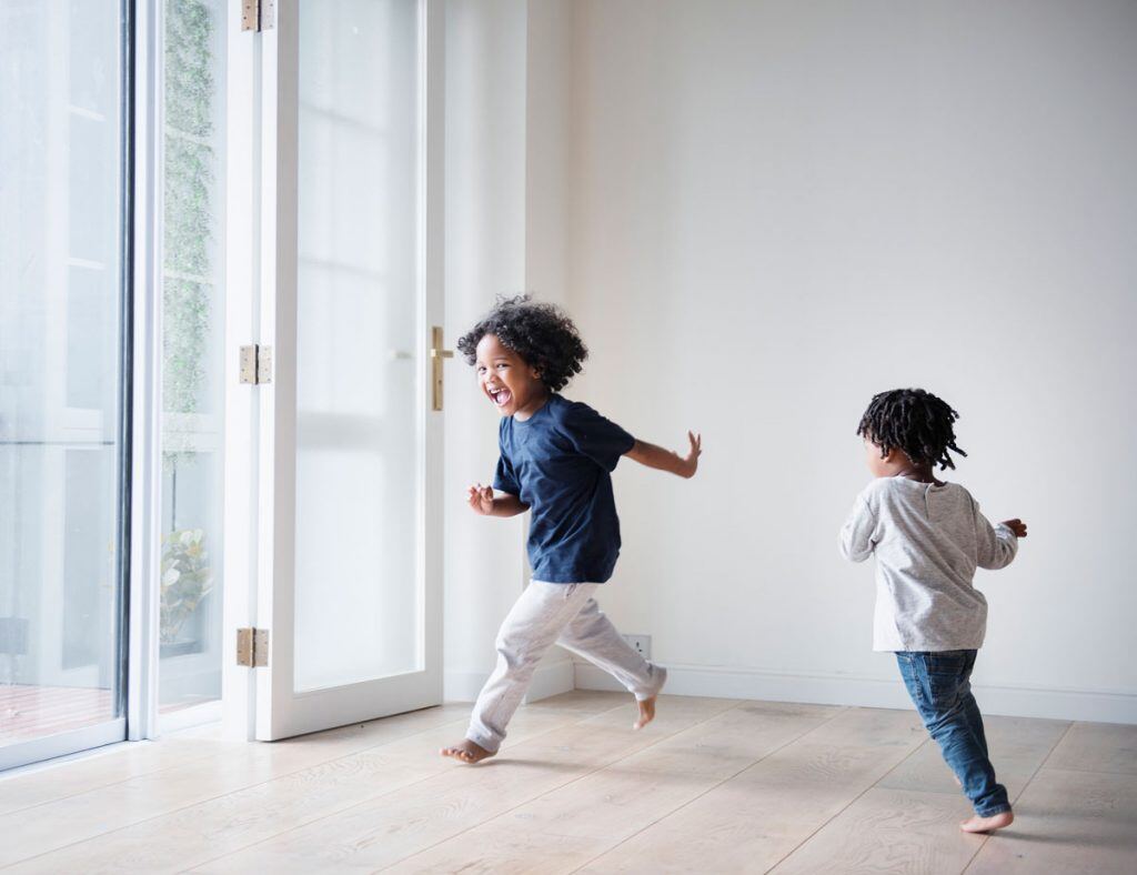 Two kids running and playing inside | Motif