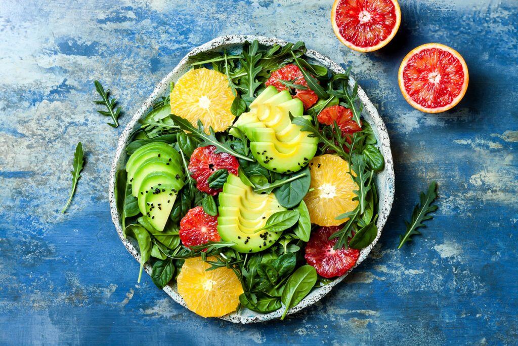 A plate of salad with different fruits on top | Motif