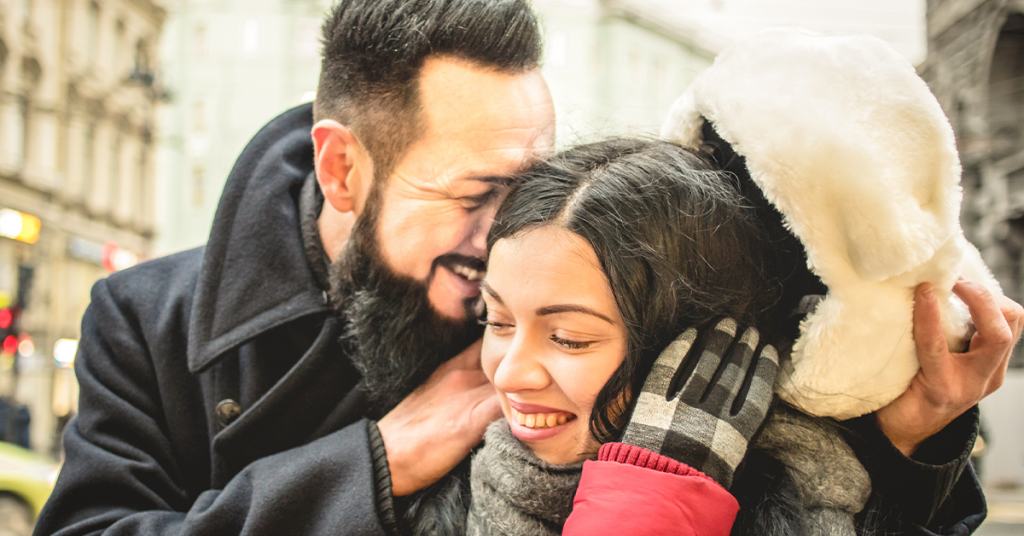 A whisper in a loved one’s ear is a casual yet intimate couple photography pose.