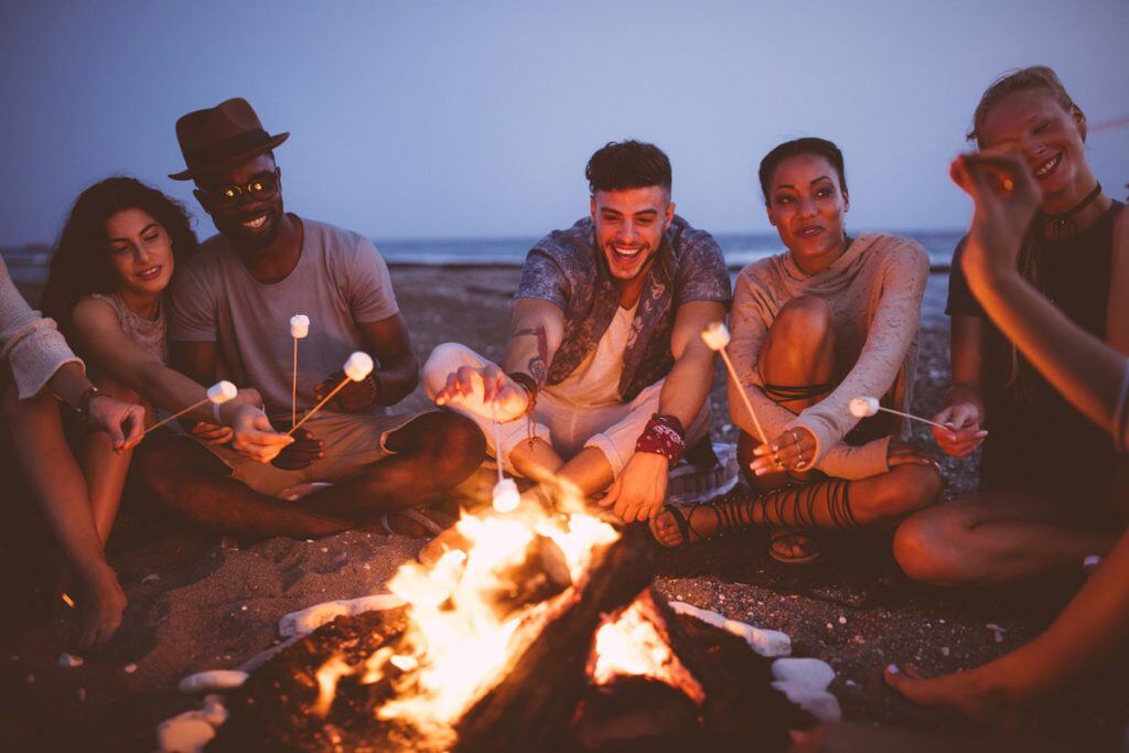 Friends enjoying a bonfire on the beach