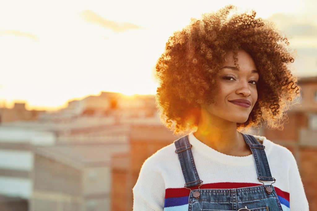 Portrait of young woman on a rooftop during the golden hour.