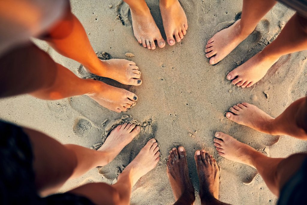 Group of friends' feet on the beach