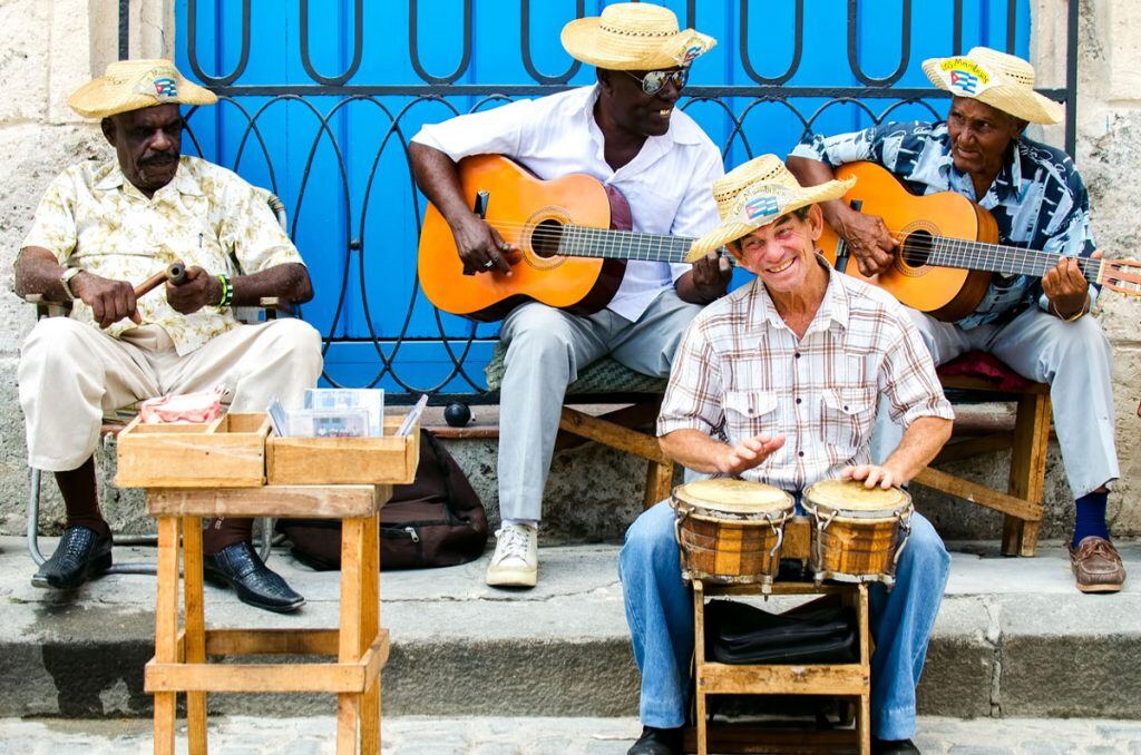 Musicians playing their instruments on a street corner | Motif