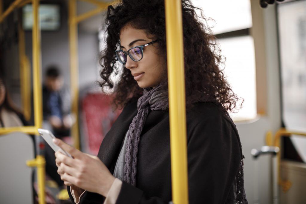 Organize photos during down time, like this woman commuting on the bus.