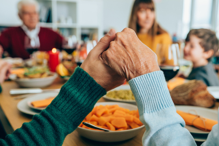 Closeup of two people holding hands for the blessing is a great Thanksgiving photo card idea.