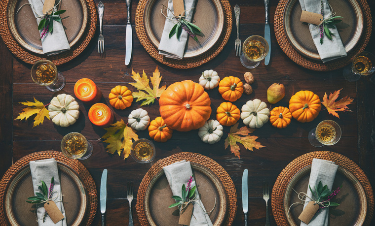 Overhead shot of place settings and pumpkins on the table is a great Thanksgiving photo card.