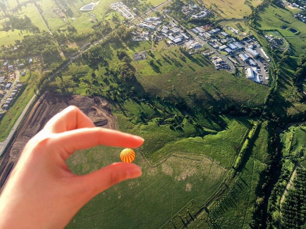 With forced perspective photography, make your hand hold a hot air balloon above ground.