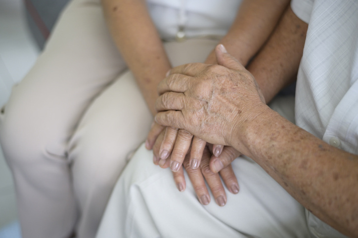 DIY Christmas gift idea: grandparents photo book with a closeup of them holding hands.