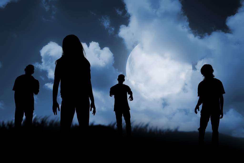 A group of zombies walking at night make for a spooky Halloween photo idea.