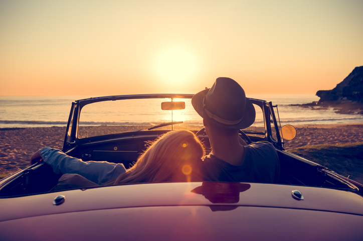 A romantic beach engagement photo at sunset.