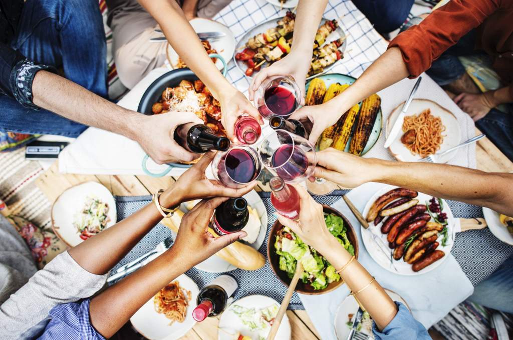 A photo book idea can be as simple as a BBQ dinner with friends, clanking glasses to cheers.