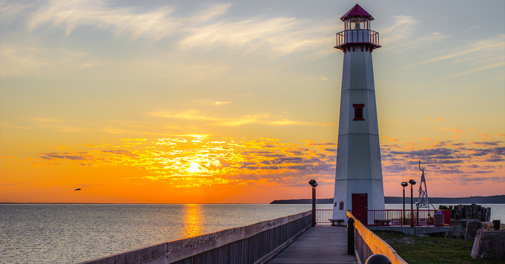 The rule of thirds used to show the lighthouse and sunset placed in sections in the frame.