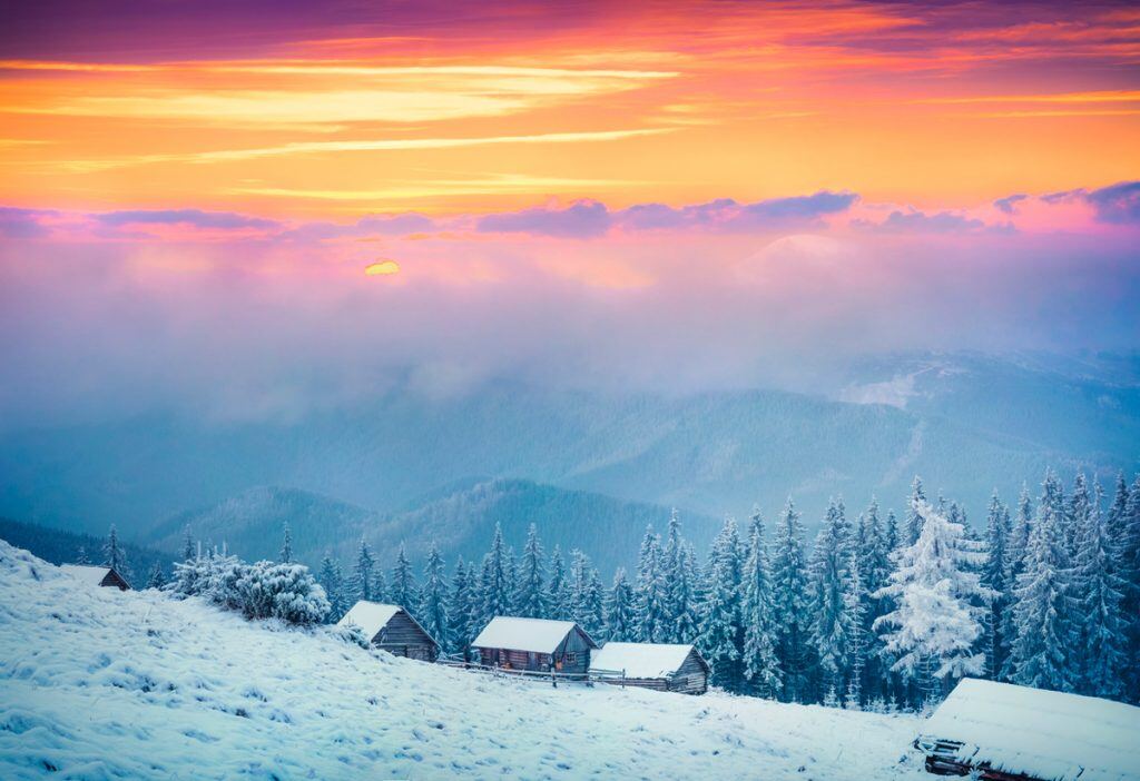 Snowy Hillside During Sunset